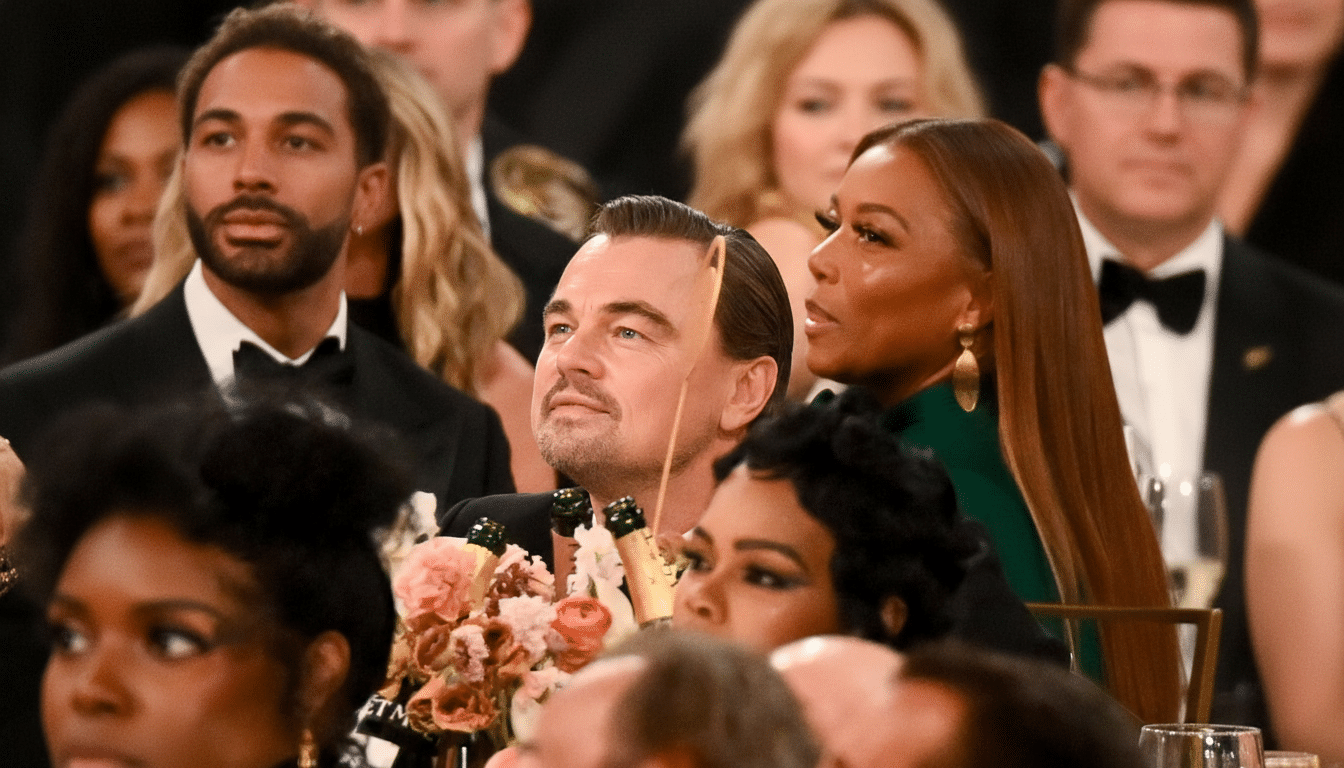 Leonardo DiCaprio looking up and to the left, surrounded by other attendees at an event.