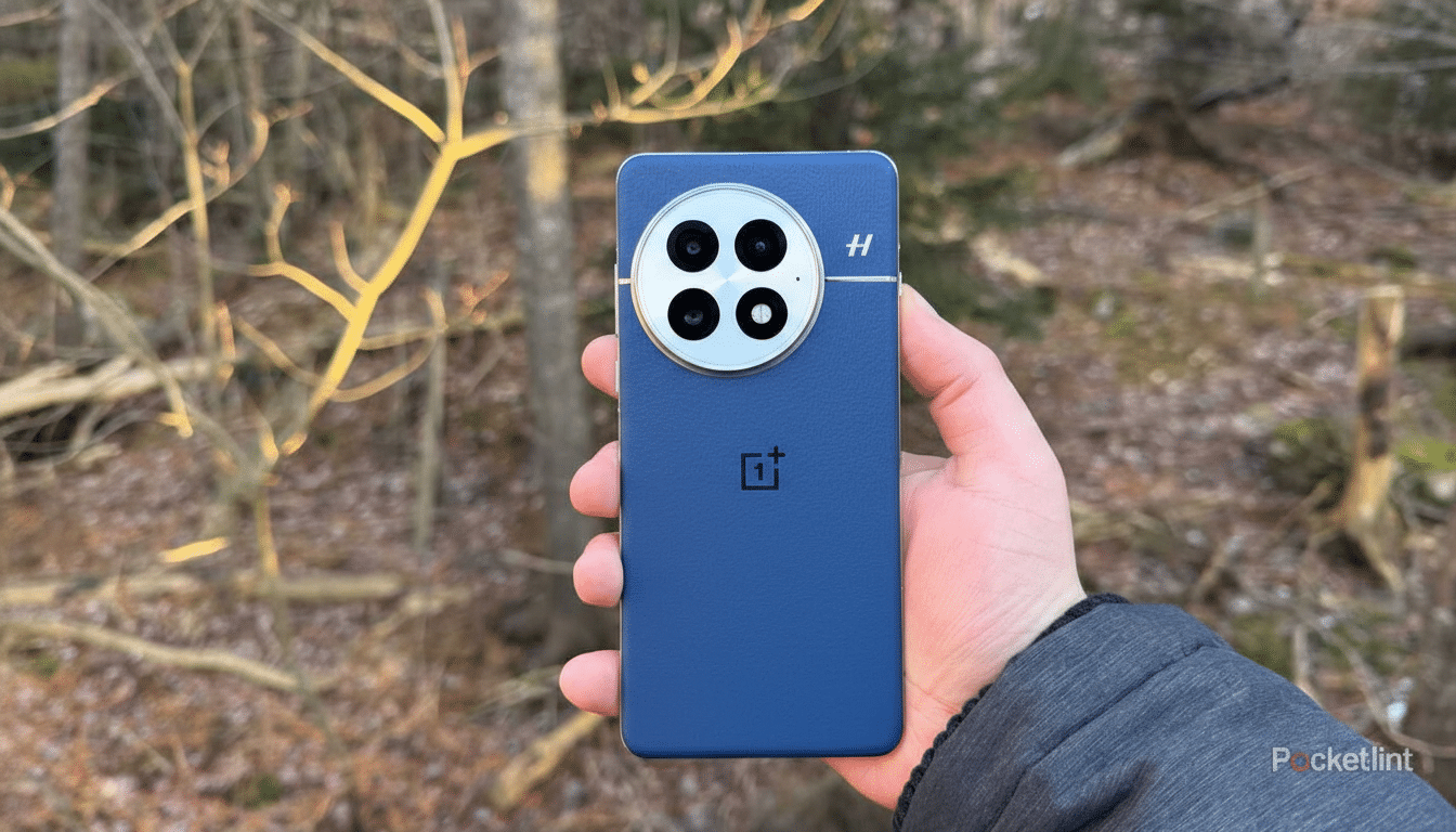 A hand holding a blue OnePlus phone with a large circular camera module featuring four lenses, set against a blurred outdoor background of trees and branches.