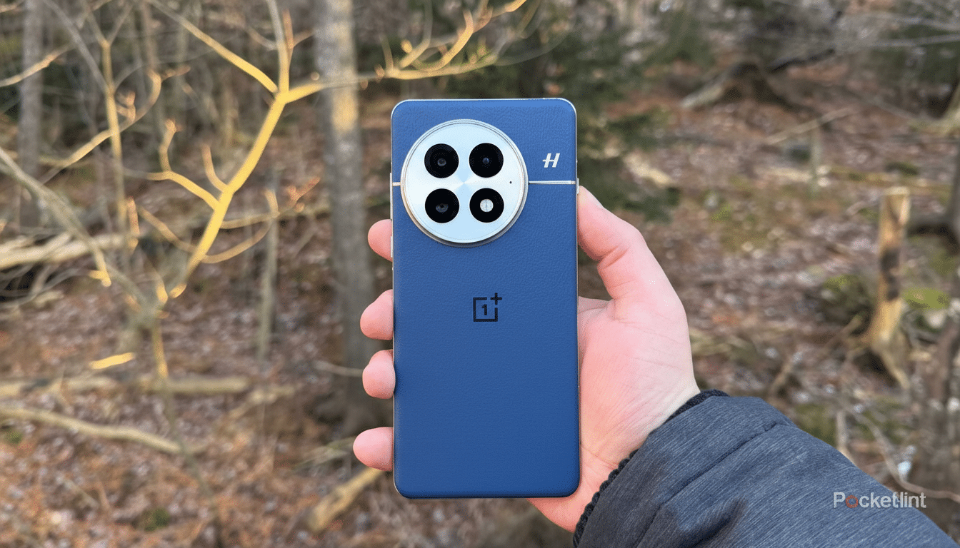 A hand holding a blue OnePlus smartphone with a large circular camera module featuring four lenses, set against a blurred outdoor background of trees and branches.