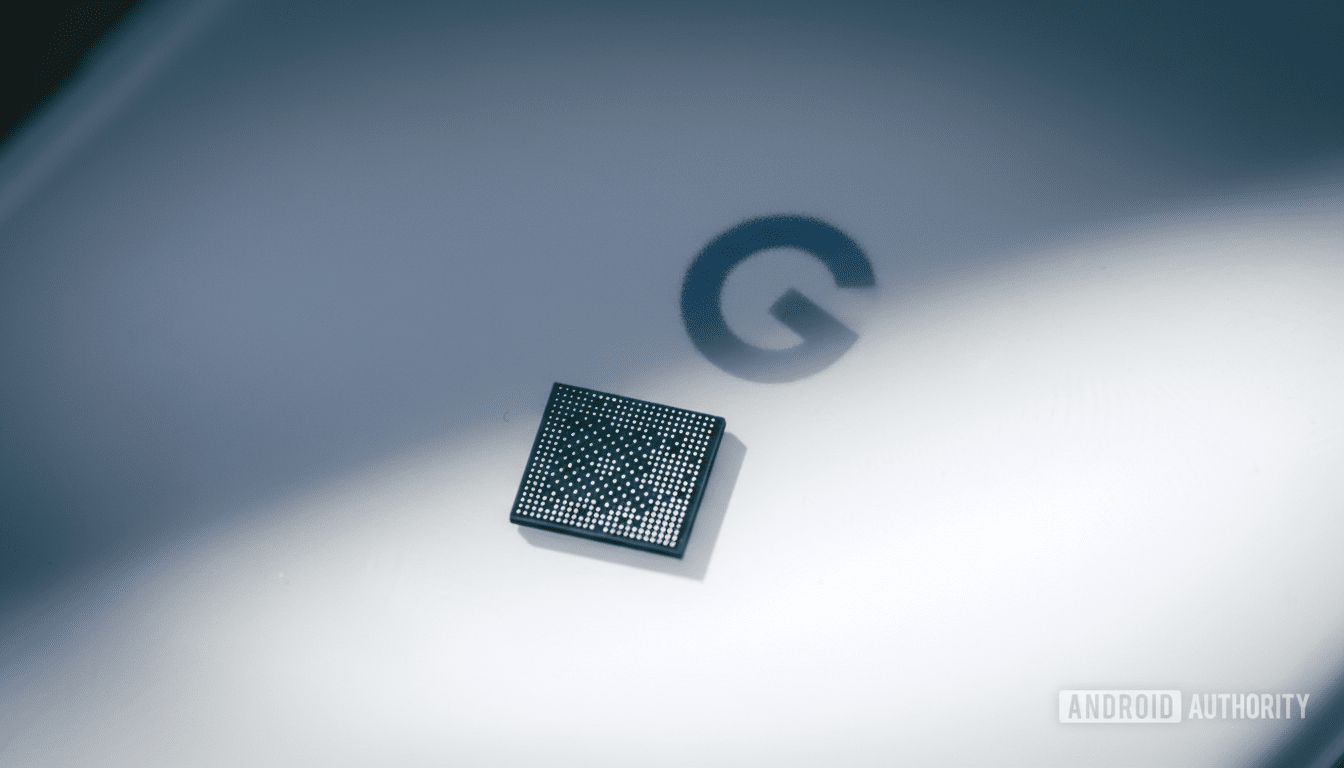 A close-up shot of a small, square computer chip resting on a white surface with a subtle G logo in the background, illuminated by a diagonal beam of light.