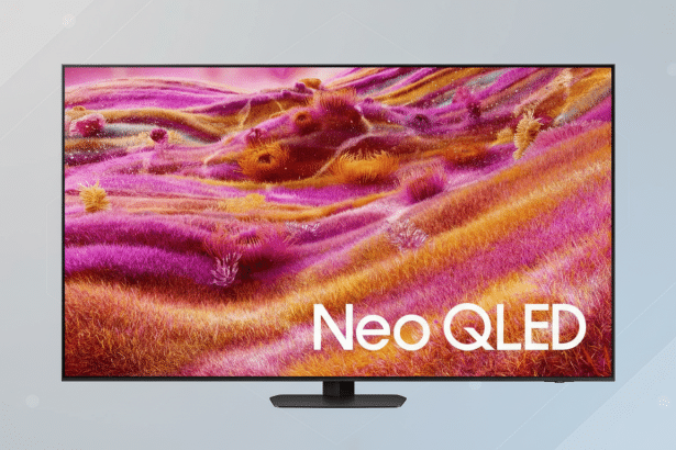A Neo QLED television displaying a vibrant, abstract image of pink and orange textured forms, set against a professional light gray background with subtle geometric patterns.