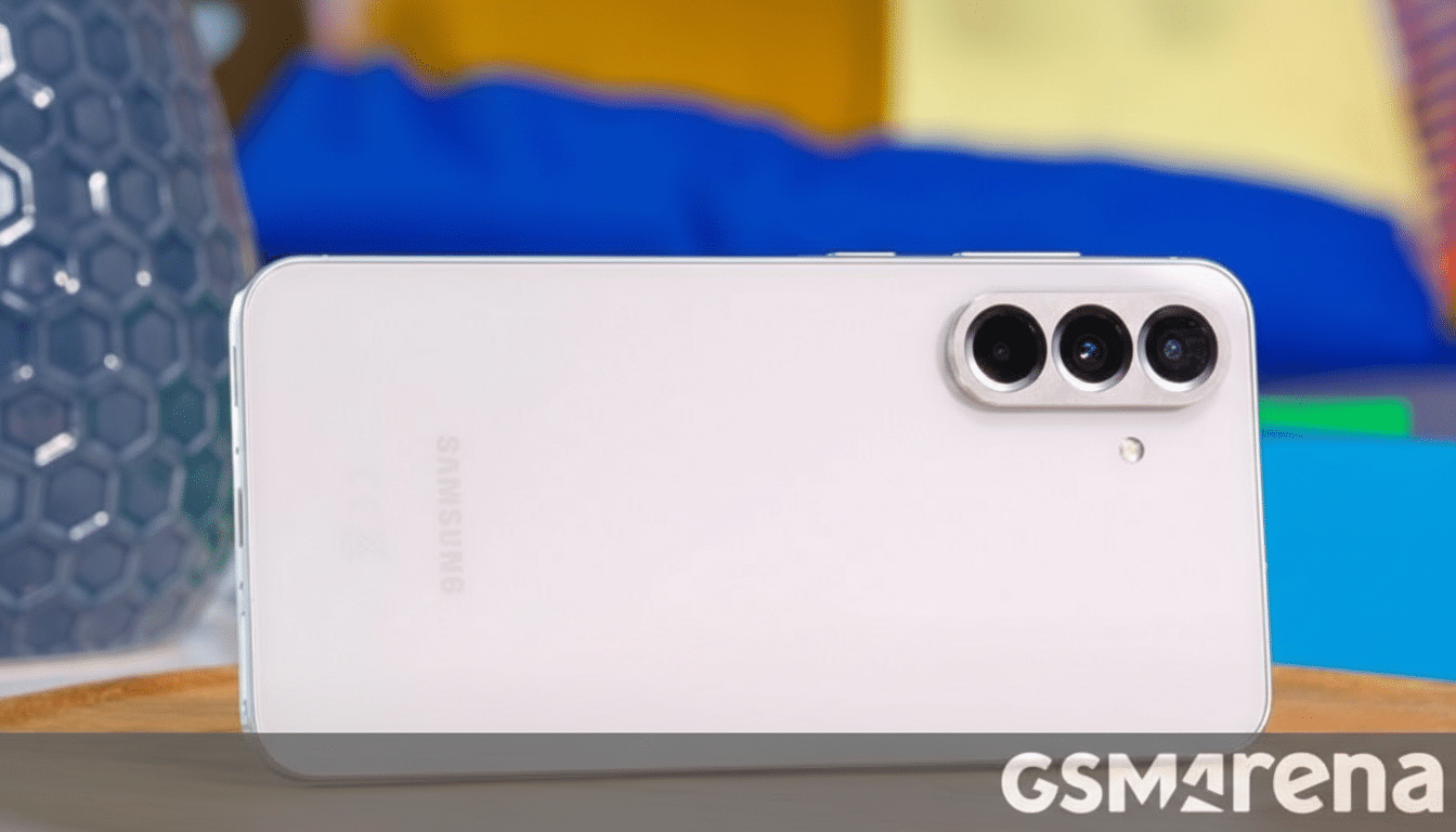 A white Samsung smartphone with three camera lenses on the back, shown in a 16:9 aspect ratio.