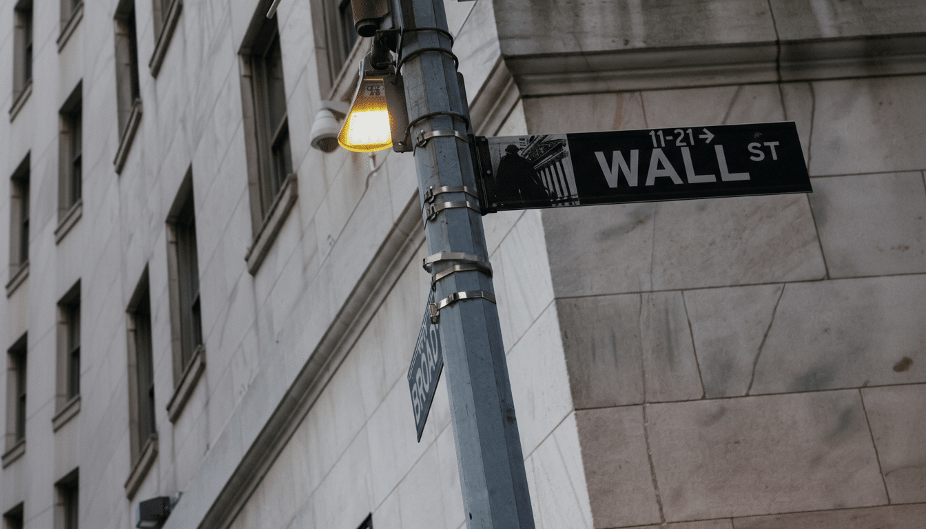 A street sign for Wall Street, with a building in the background.
