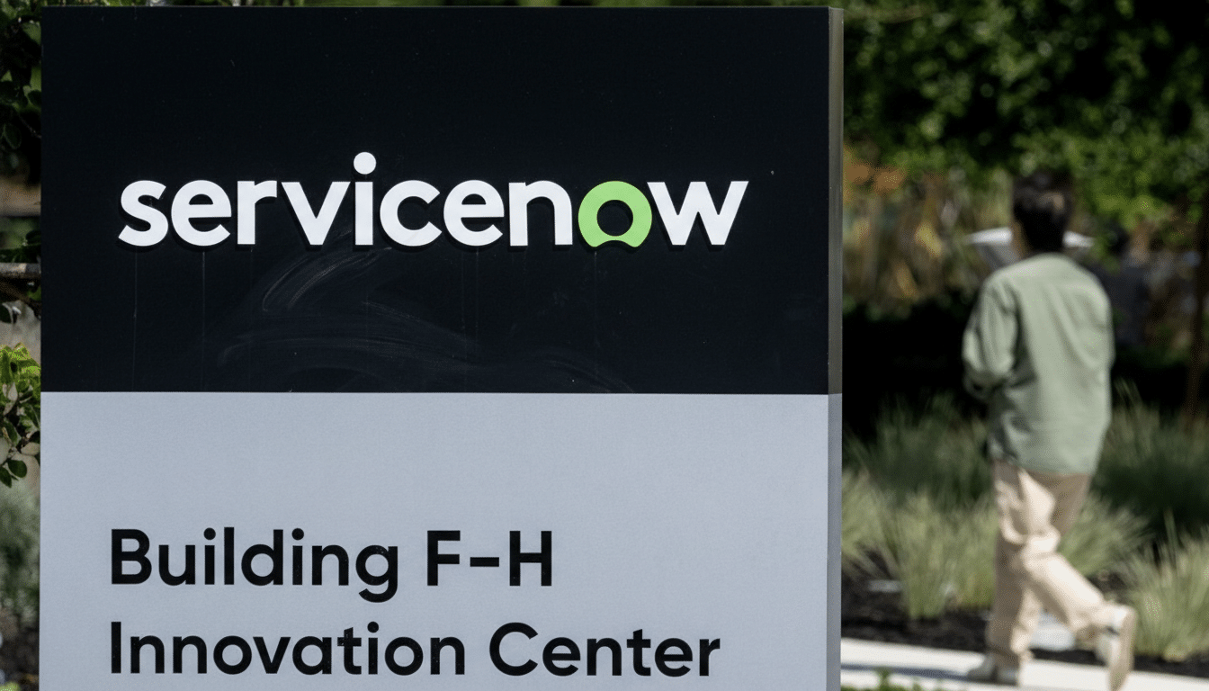 A sign for ServiceNows Building F-H Innovation Center, with a person walking in the background.