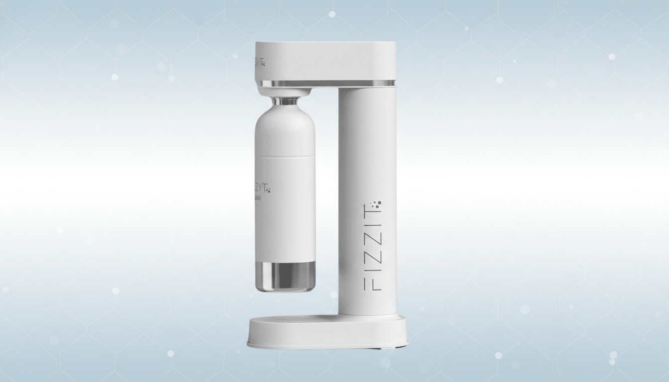 A white Fizzit soda maker with a bottle attached, set against a light blue background with subtle geometric patterns.
