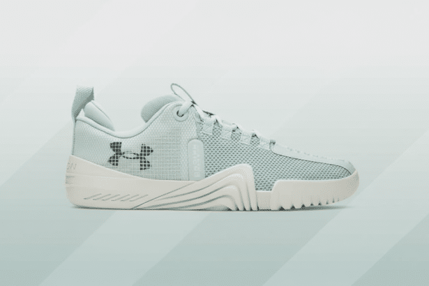A light blue Under Armour sneaker with a white sole, presented on a professional flat design background with soft blue and grey gradients.