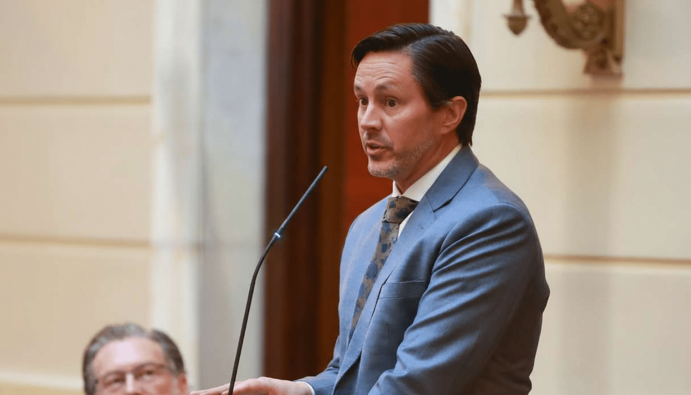 A man in a suit speaking at a podium.