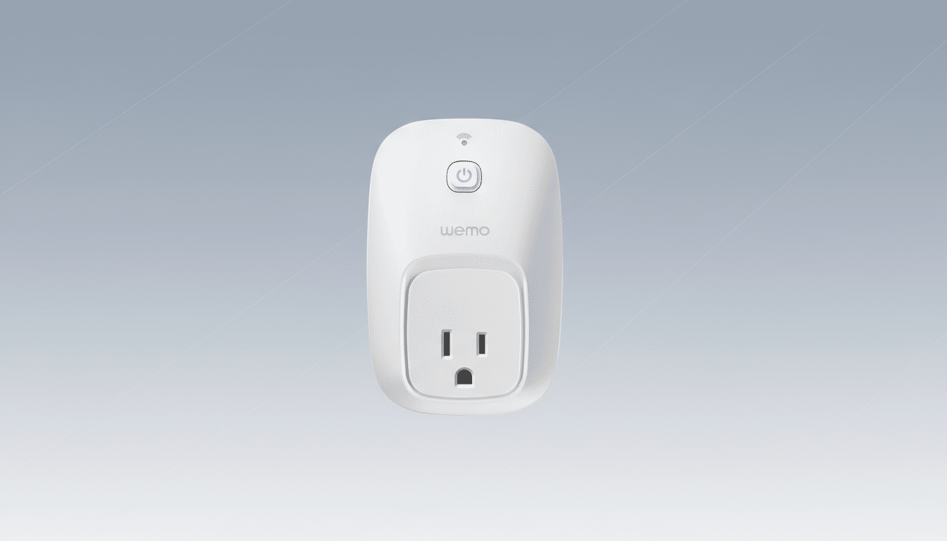 A white WeMo smart plug with a power button and Wi-Fi indicator on a professional flat design background with a soft gray gradient.