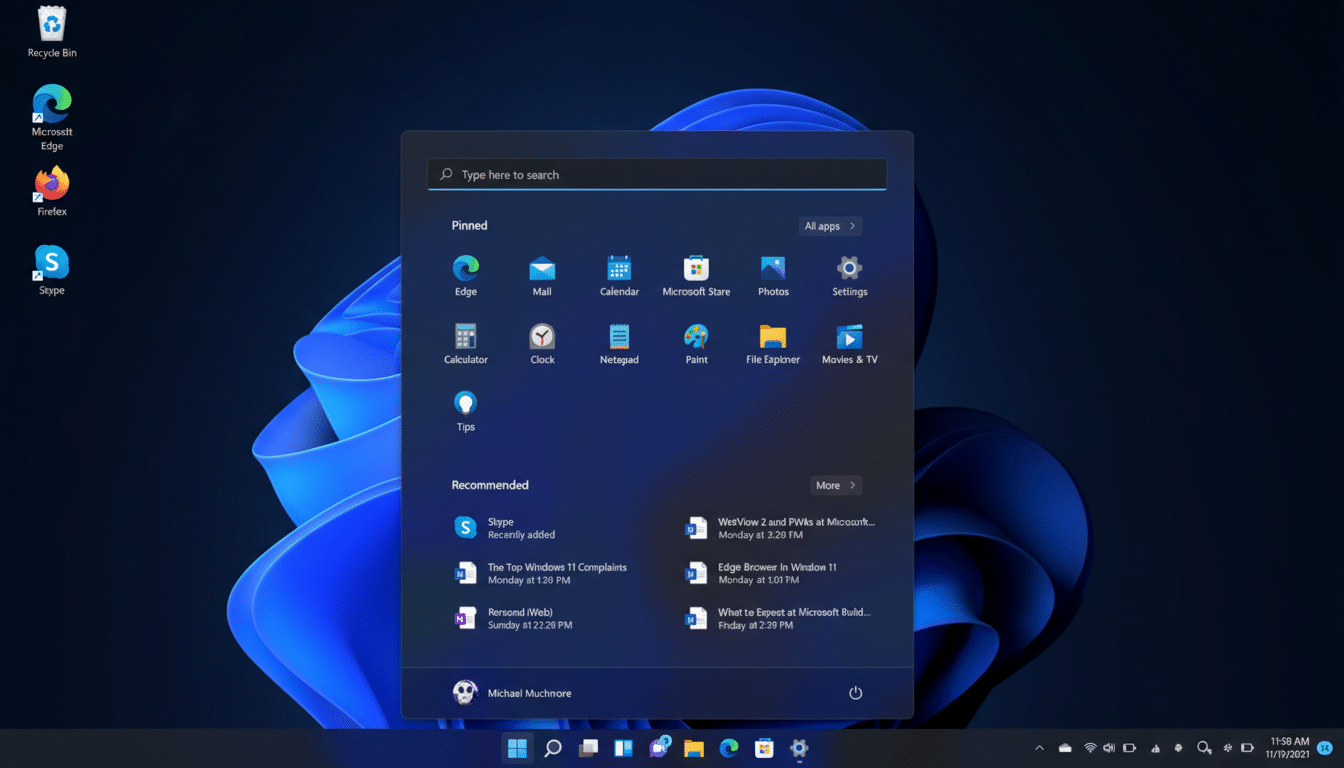 A screenshot of the Windows 11 desktop with the Start menu open, displaying pinned applications and recommended items.