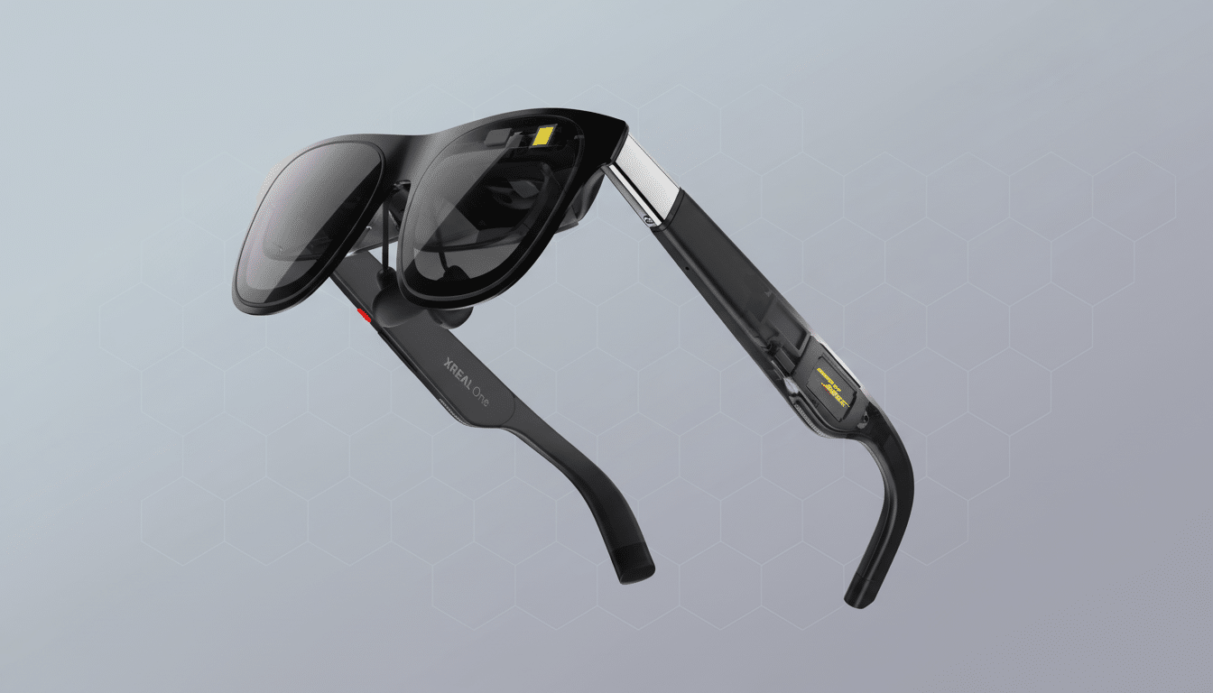 A pair of black XREAL One smart glasses with dark lenses and silver accents, presented at an angle against a professional gray background with a subtle hexagonal pattern.