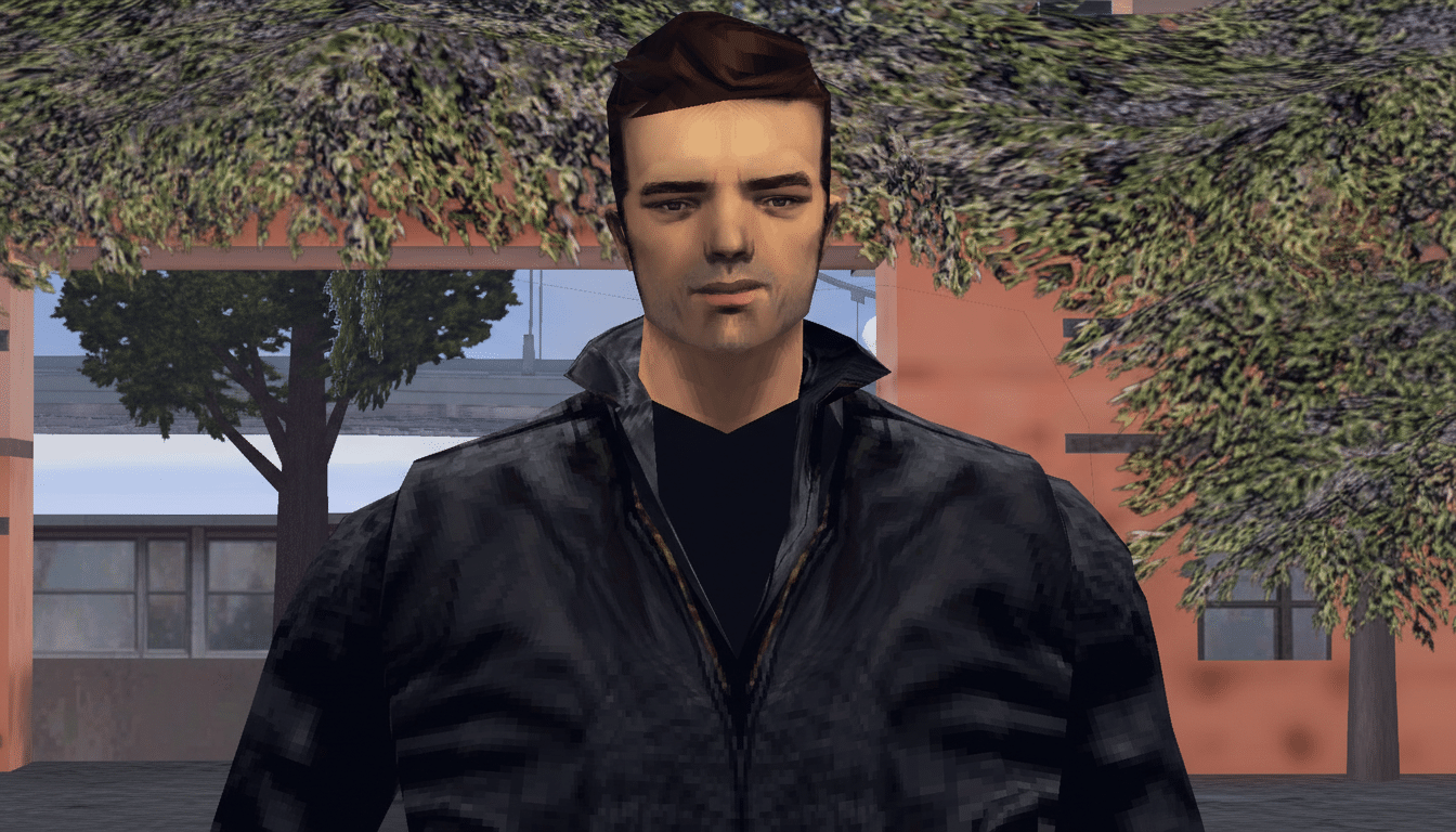 A man with dark hair and a black jacket, standing outdoors with trees and buildings in the background.