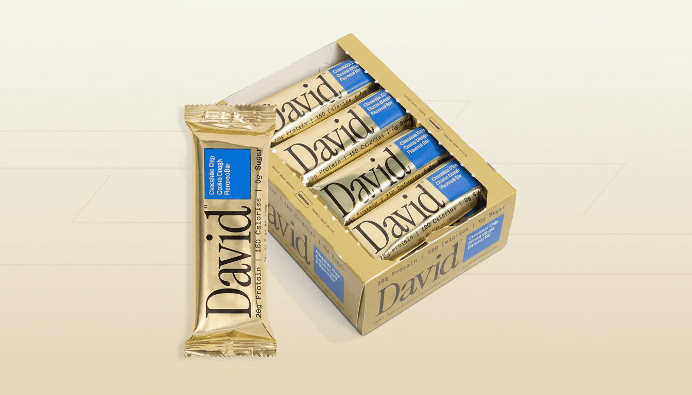 A gold-wrapped David brand chocolate chip cookie dough flavored bar stands upright next to an open box containing several more bars, all presented on a professional flat design background with a soft gradient.