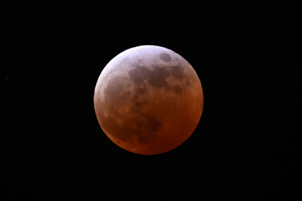 Moon in Earths shadow during lunar eclipse visible in North America and Asia