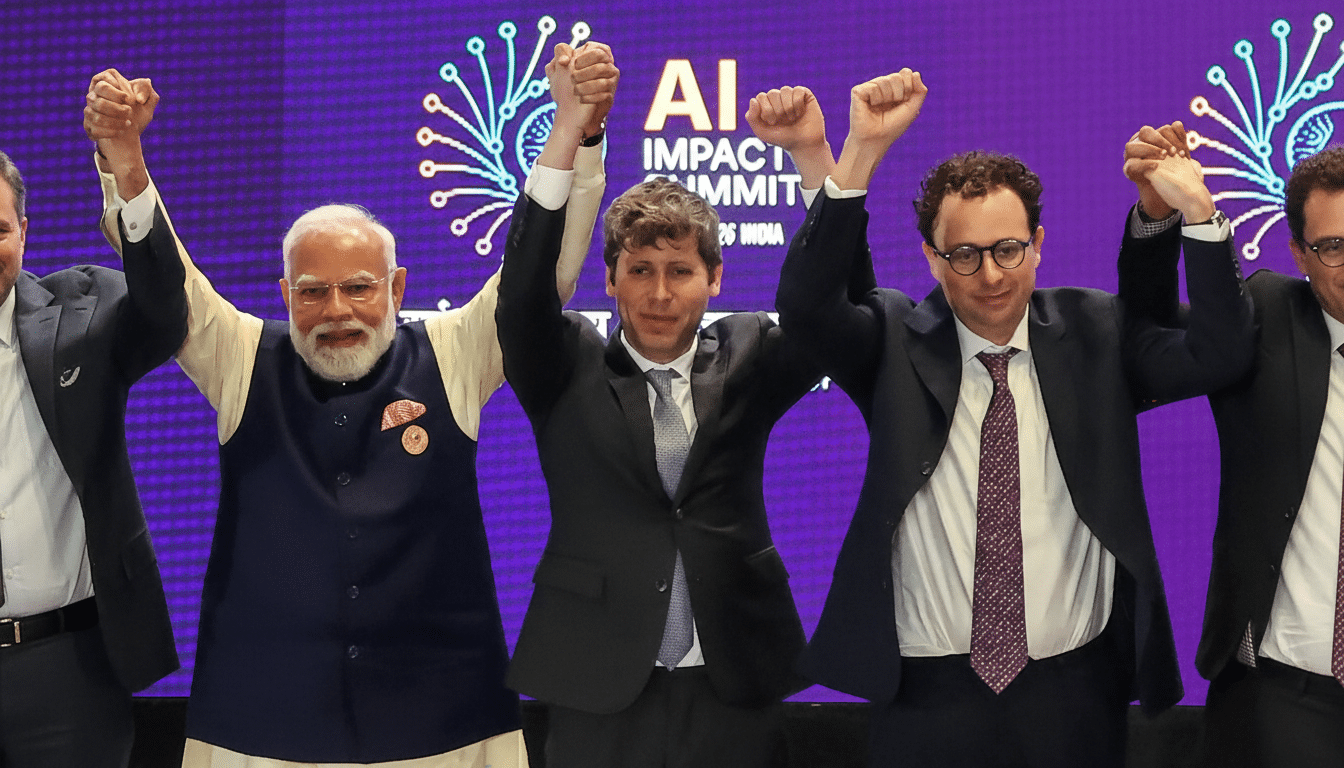 A group of men, including Narendra Modi and Sam Altman, stand with their arms raised and hands clasped, celebrating at the AI Impact Summit.