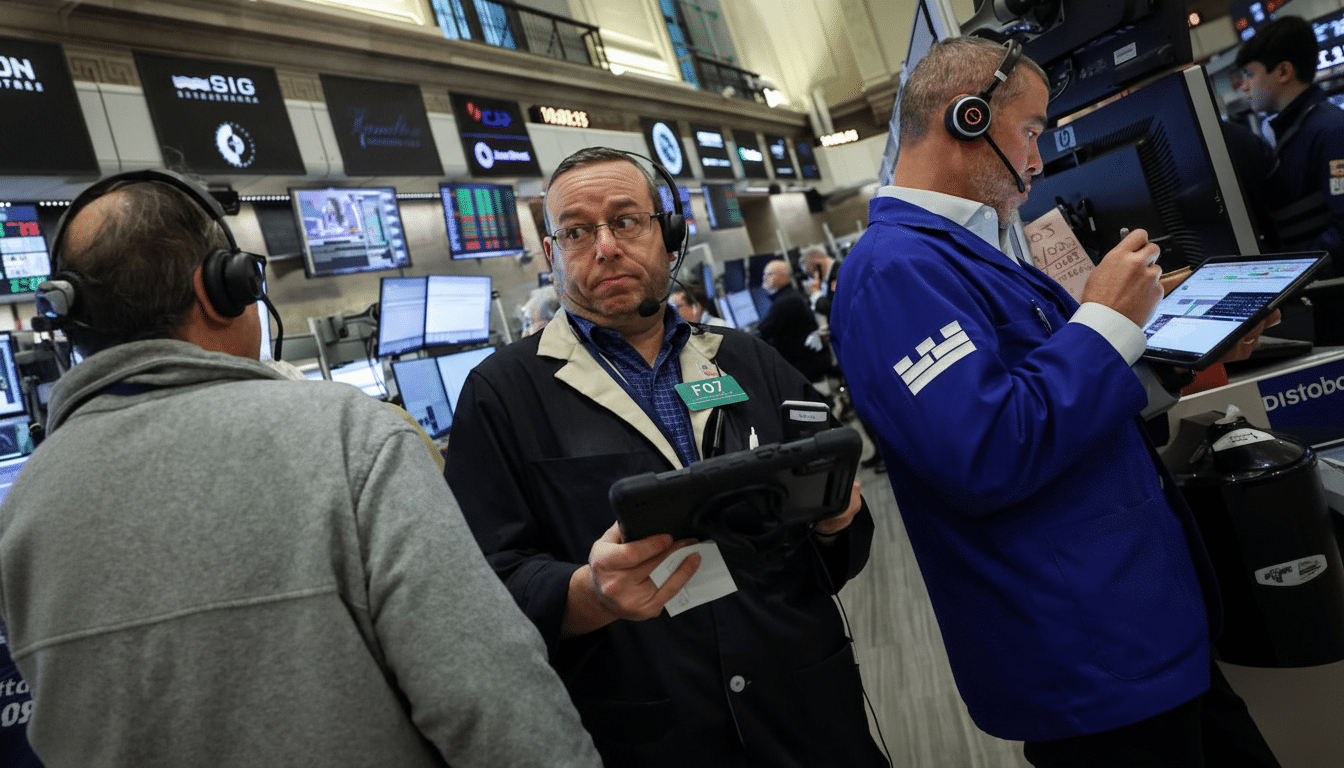 Three men in a trading room, two wearing headsets and looking at screens, with one in the foreground from behind, and another in the middle looking towards the viewer.