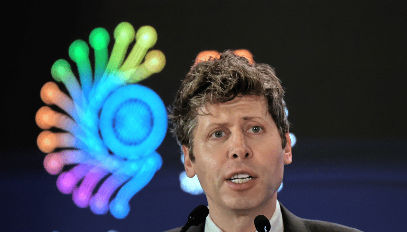 A man with curly brown hair speaks into two microphones, with a colorful, swirling graphic in the background.