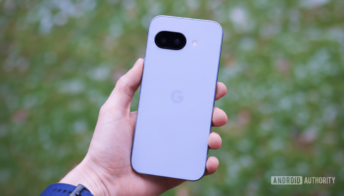 A hand holding a light purple smartphone with a black camera module and a G logo on the back, against a blurred green background.