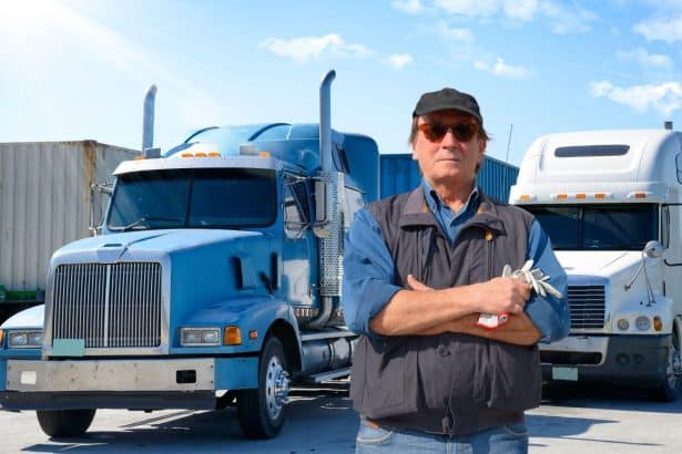 Image 1 of Truck Driver Insurance Checklist: What You Need Beyond Cargo and LiabilityImage Alt text: Truck driver standing near trucks