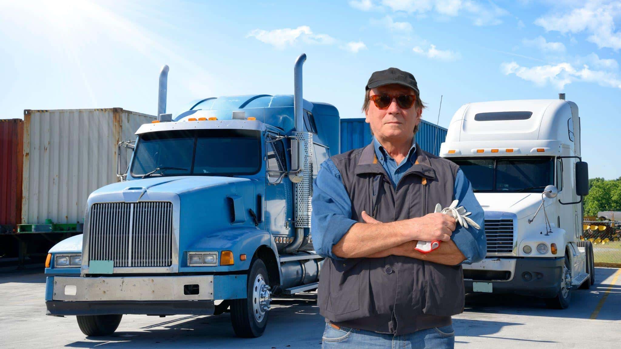 Image 1 of Truck Driver Insurance Checklist: What You Need Beyond Cargo and LiabilityImage Alt text: Truck driver standing near trucks