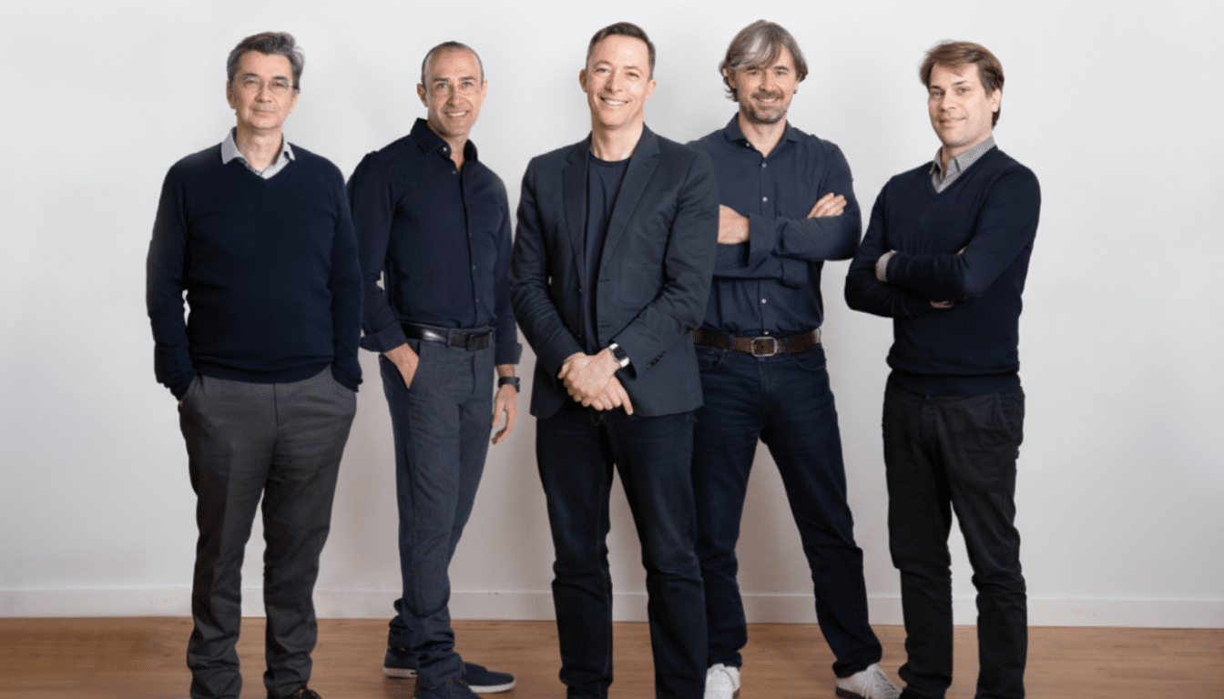 Five men standing in a line, smiling at the camera.