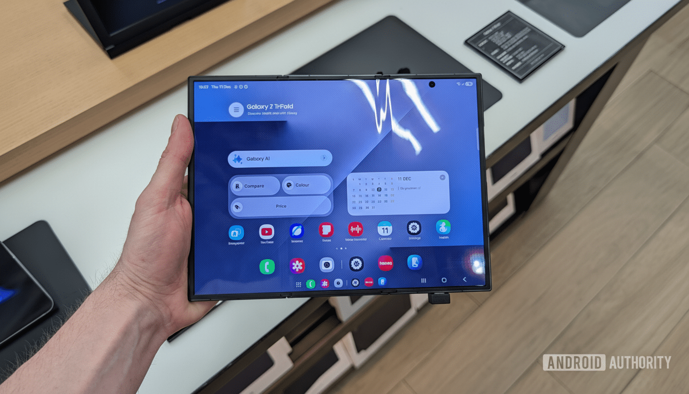 A hand holding a foldable smartphone displaying a home screen with various app icons and widgets.