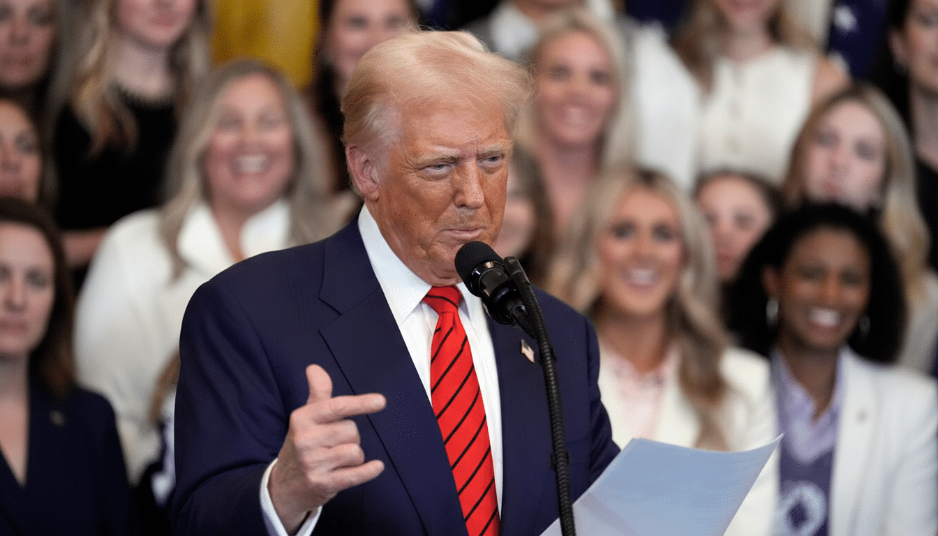 Donald Trump speaking at a podium with a crowd of people in the background.