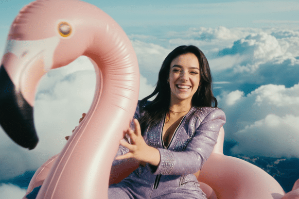 A smiling woman in a shimmering purple outfit sits on a pink inflatable flamingo against a backdrop of clouds and blue sky.