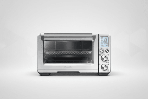 A silver Breville smart oven with an air fryer basket visible inside, set against a professional light gray gradient background.