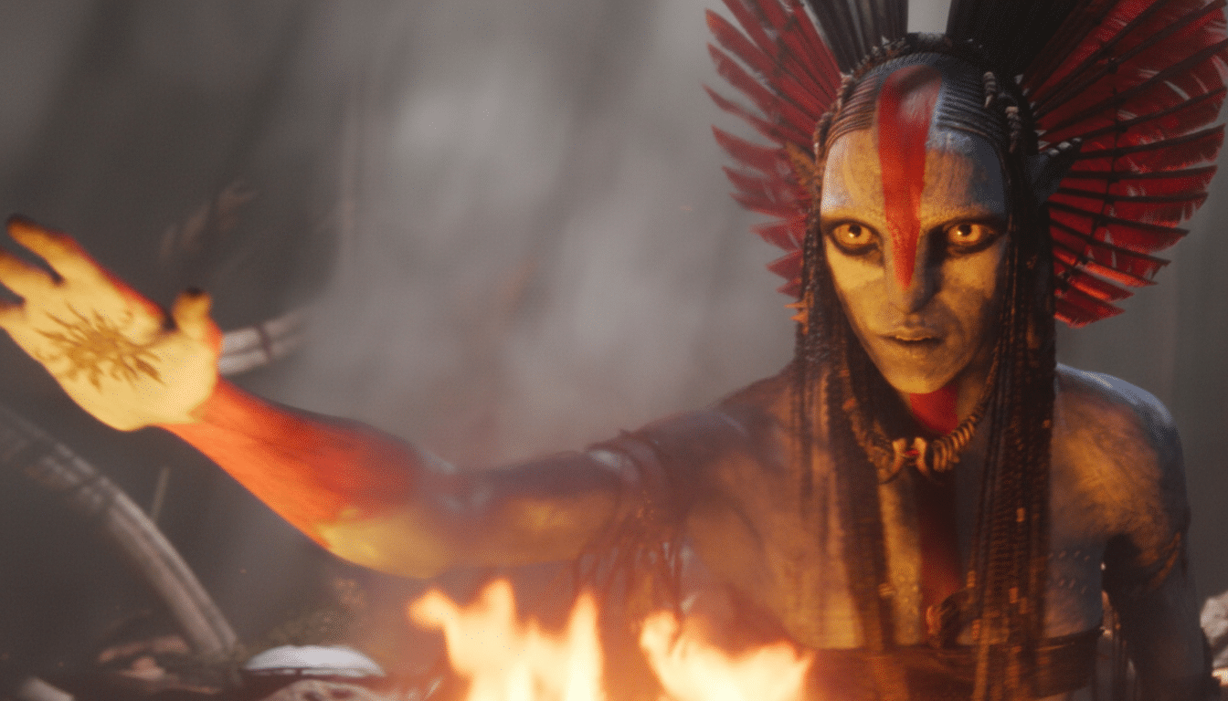 A person with elaborate red and white face paint, yellow eyes, and a red feathered headdress, extending their hand with a sun symbol on the palm, standing in front of a fire.