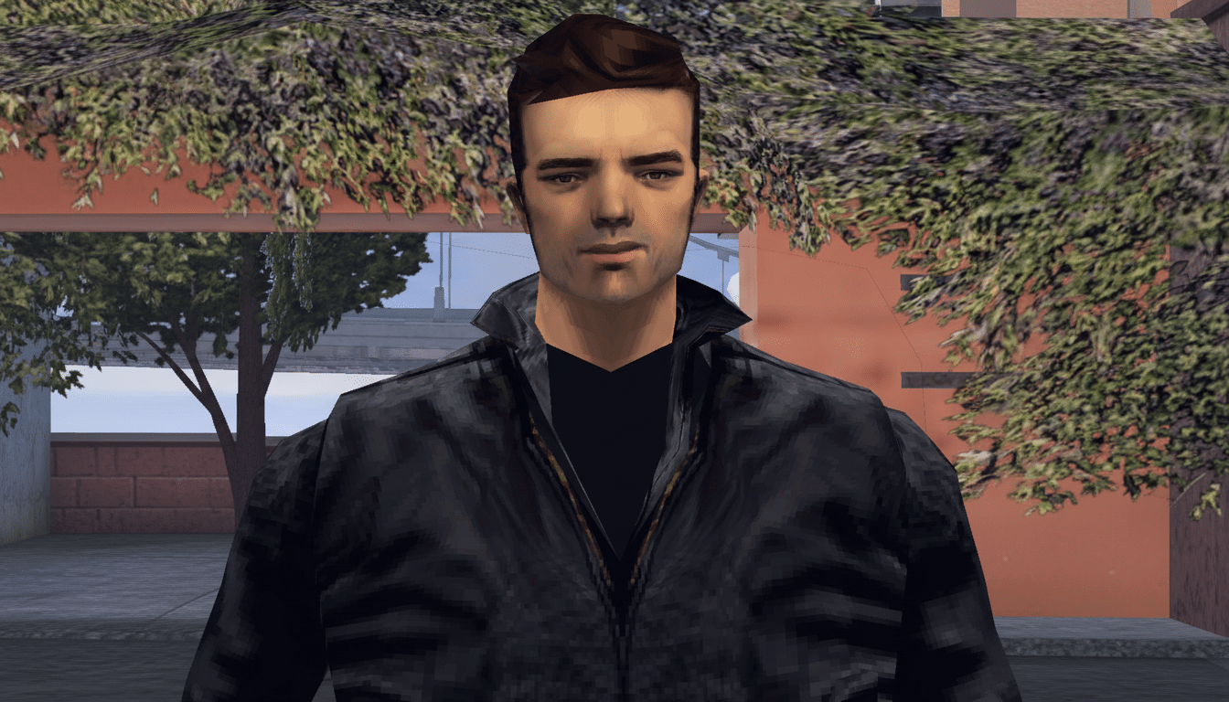 A man with dark hair and a black jacket, standing outdoors with trees and buildings in the background, resized to a 16:9 aspect ratio.