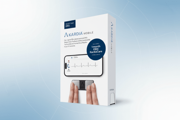 A white box for Kardia Mobile, a mobile 1-lead EKG device, is displayed at a slight angle on a professional flat gray background with a subtle gradient. The box features text describing its FDA clearance and ability to detect various heart conditions, along with an image of the device and a smartphone screen showing an EKG reading. The box also highlights a 1 month FREE KardiaCare offer.