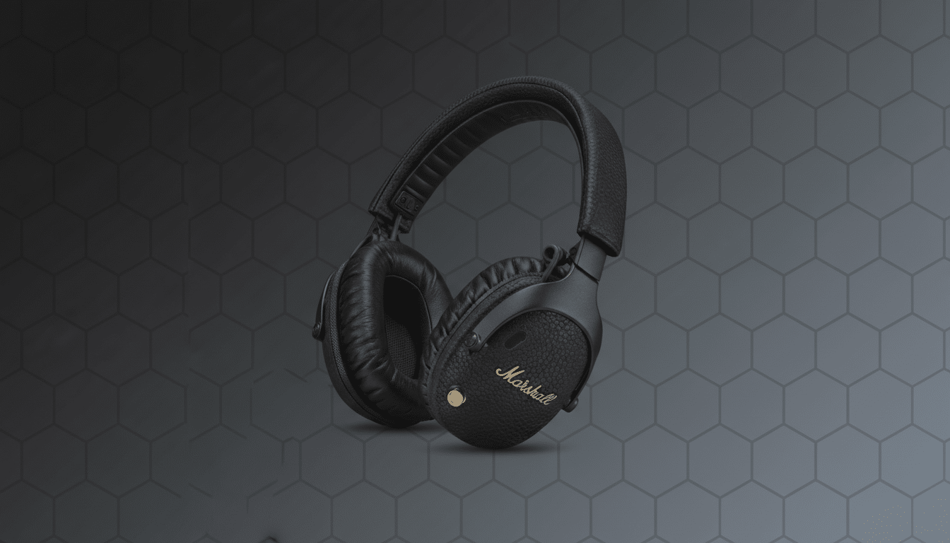 A pair of black Marshall headphones with gold lettering on a dark gray background with a subtle hexagonal pattern.