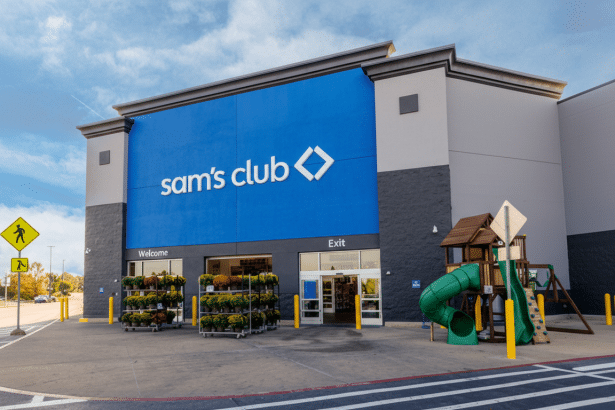 The exterior of a Sams Club store with a blue facade and a playground to the right.