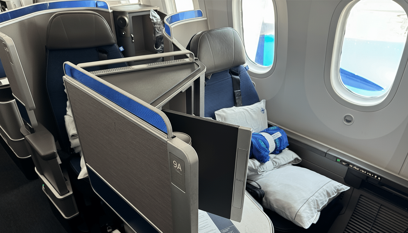 A professional shot of an airplanes business class cabin, featuring spacious seats, a side table, and a window view, resized to a 16:9 aspect ratio.