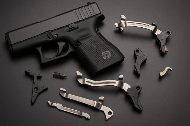 Close-up of Glock trigger assembly showing aftermarket parts affecting internal mechanics